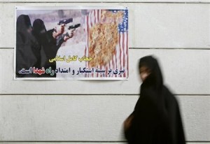 Iranian woman walks past an anti-U.S. poster during a visit to a war museum in Khorramshahr, southwest of Tehran