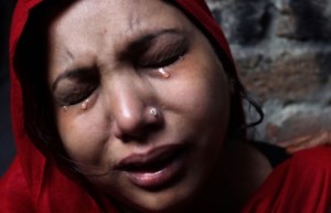 A Pakistani Christian woman weeps after visiting  her home which was damaged by an angry Muslim mob in Lahore, Pakistan, Sunday, March 10, 2013. Hundreds of Christians clashed with police in eastern and southern Pakistan on Sunday, a day after a Muslim mob burned dozens of homes owned by members of the minority religious group in retaliation for alleged insults against Islamís Prophet Muhammad. (AP Photo/K.M. Chaudary)