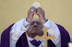 Pope Francis celebrates a mass during his visit to Lampedusa Island, southern Italy, July 8, 2013. Pope Francis makes his first official trip outside Rome on Monday with a visit to Lampedusa, the tiny island off Sicily that has been the first port of safety for untold thousands of migrants crossing by sea from North Africa to Europe. The choice of Lampedusa is a highly symbolic one for Francis, who has placed the poor at the centre of his papacy and called on the Church to return to its mission of serving them.  REUTERS/Alessandro Bianchi  (ITALY - Tags: RELIGION SOCIETY IMMIGRATION)